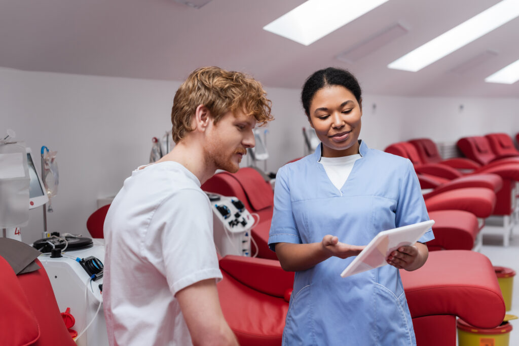 Psychiatric mental health nurse educating a patient using a digital tablet in a clinical care setting